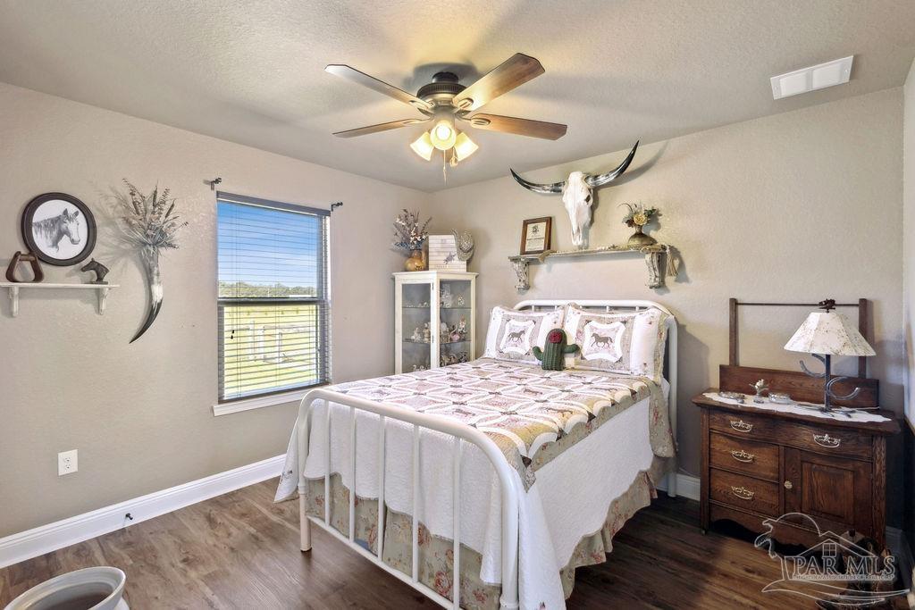 3480 Red Ryder Lane Pace, FL 32571 - Photo 29 of 47 a bedroom with a bed and a chandelier