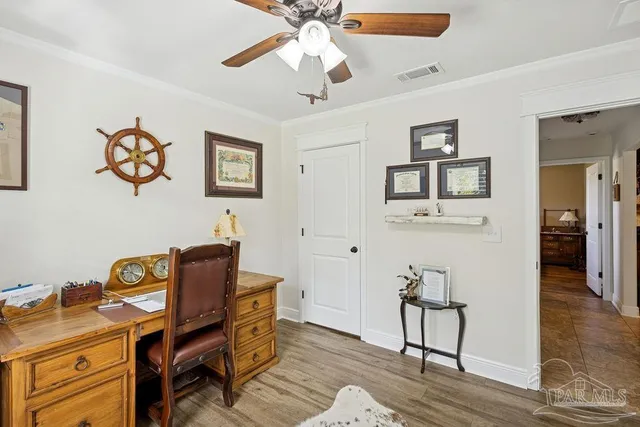 a view of a workspace with furniture and wooden floor