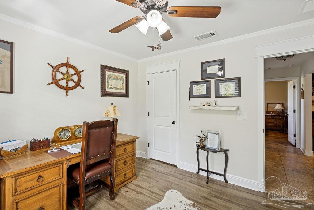 3480 Red Ryder Lane Pace, FL 32571 - Photo 30 of 47 a view of a workspace with furniture and wooden floor
