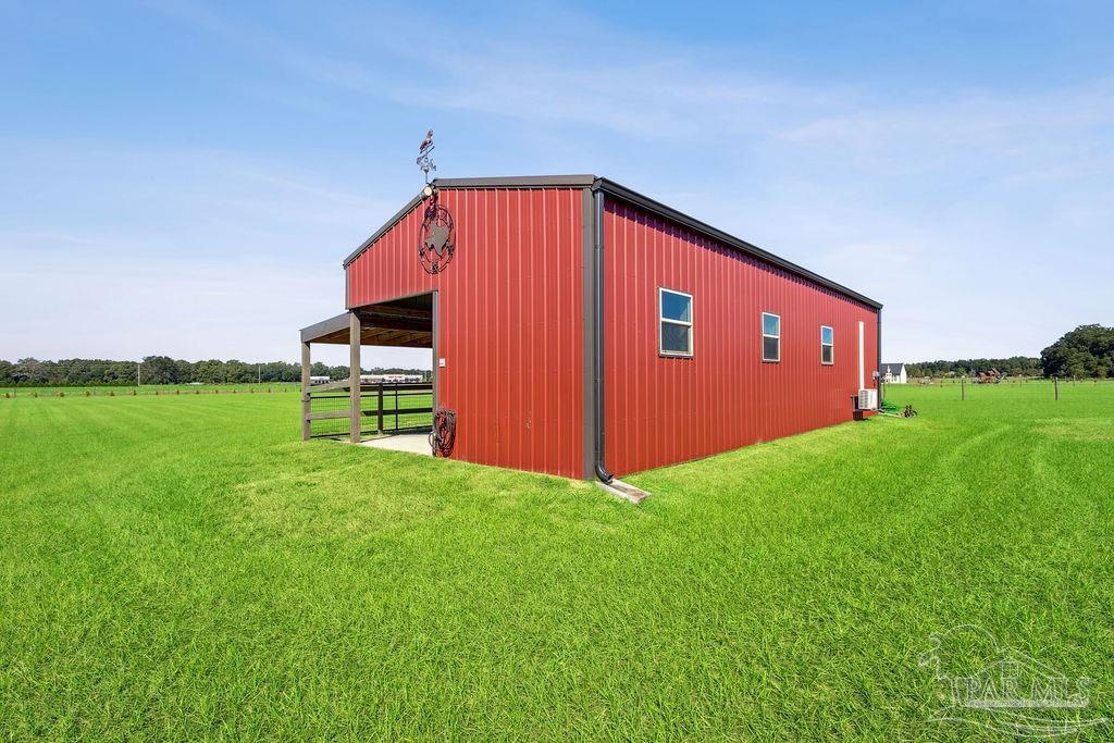 3480 Red Ryder Lane Pace, FL 32571 - Photo 3 of 47 a blue bench sitting in front of a house