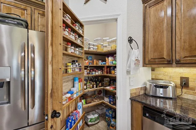 a view of a kitchen with fridge and rack