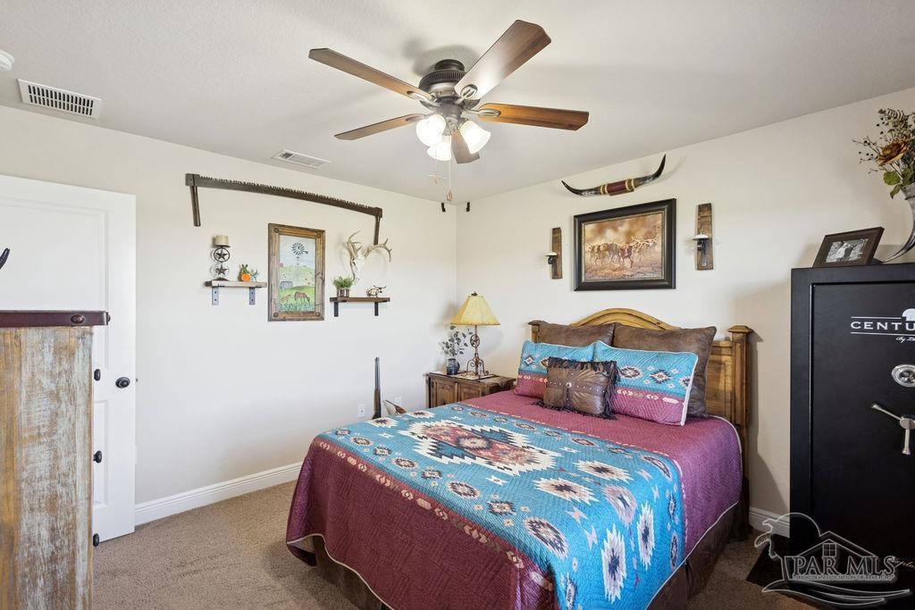 3480 Red Ryder Lane Pace, FL 32571 - Photo 35 of 47 a bedroom with a bed and a chandelier