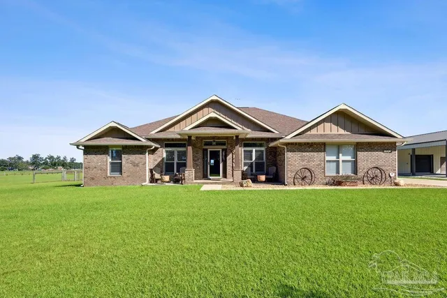 a front view of a house with a garden and yard