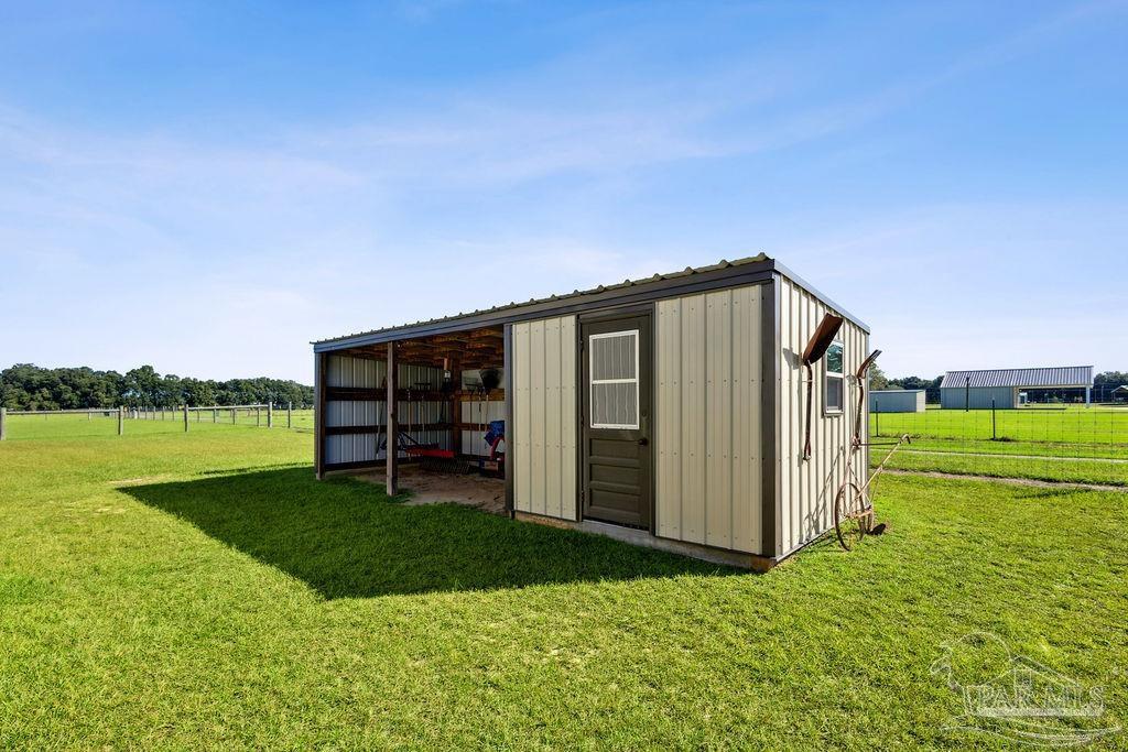 3480 Red Ryder Lane Pace, FL 32571 - Photo 44 of 47 a backyard of a house with lots of green space and mountain view in back