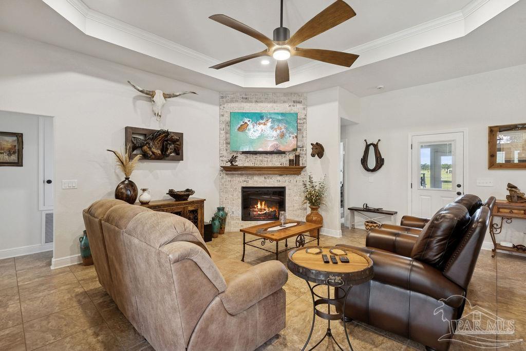 3480 Red Ryder Lane Pace, FL 32571 - Photo 8 of 47 a living room with furniture a fireplace and a window