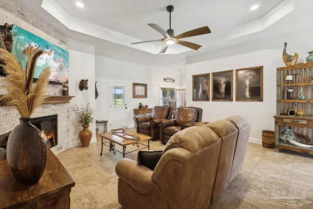 a living room with furniture a fireplace and a flat screen tv