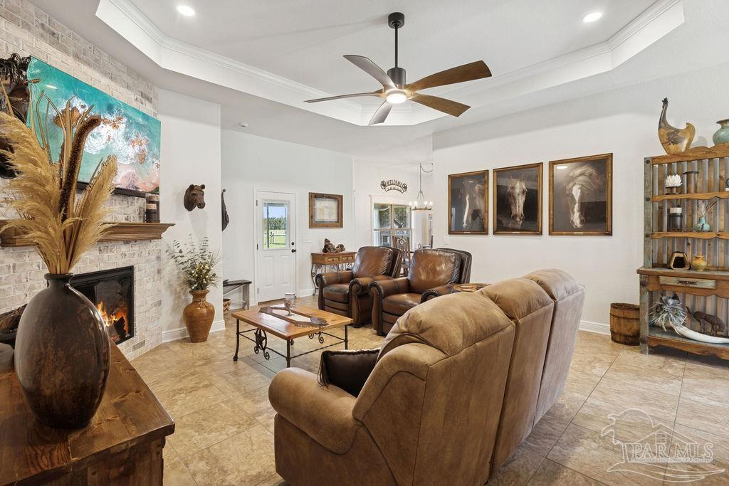 3480 Red Ryder Lane Pace, FL 32571 - Photo 10 of 47 a living room with furniture a fireplace and a flat screen tv