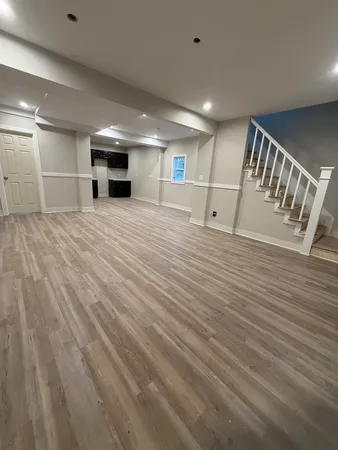 a view of empty room with wooden floor