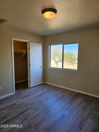 a view of a room with wooden floor