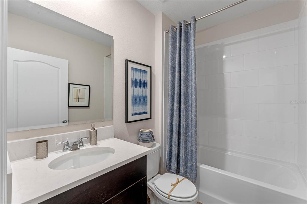 1008 Commons Way Port Port Orange, FL 32129 - Photo 23 of 27 a bathroom with a sink toilet and shower