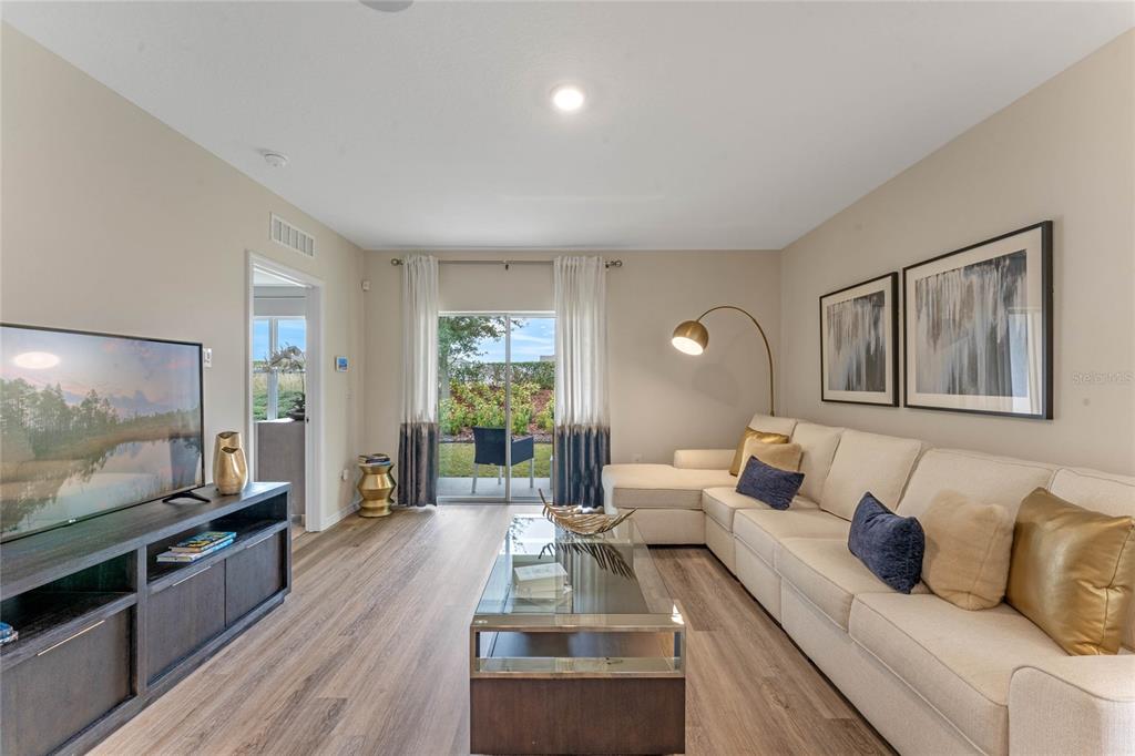 1008 Commons Way Port Port Orange, FL 32129 - Photo 10 of 27 a living room with furniture and a flat screen tv