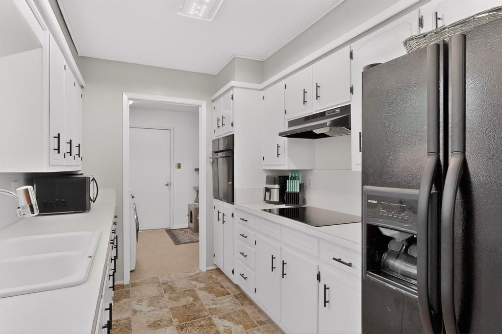 321 Redbud Street Rhome, TX 76078 - Photo 7 of 17 Fresh paint and newer black appliances.
