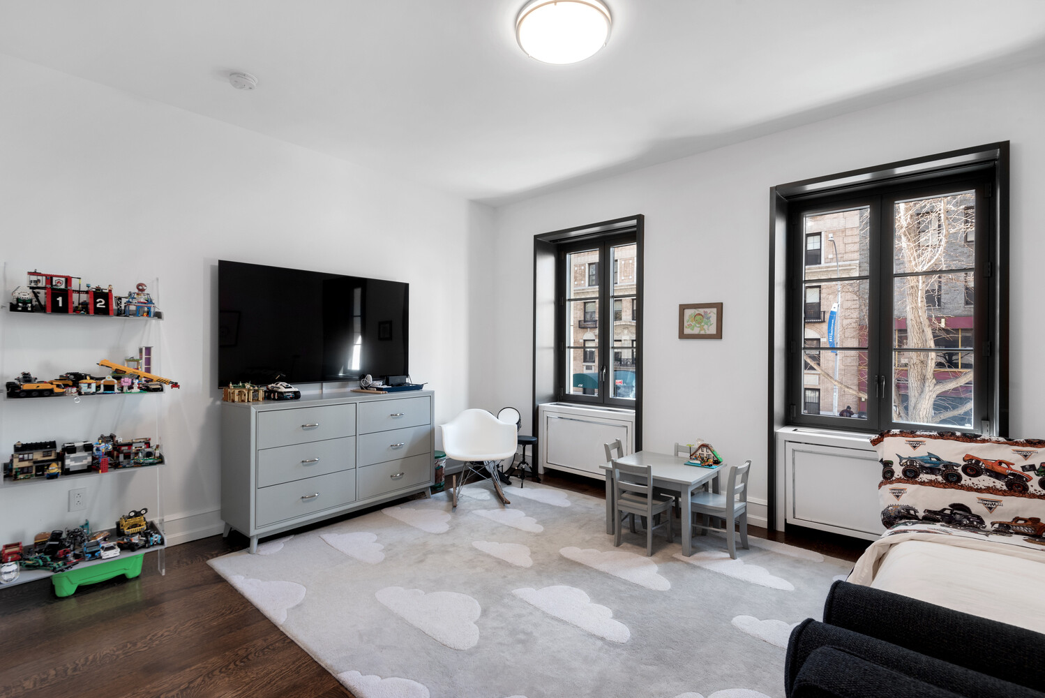 155 East 79th Street, Unit MAIS Manhattan, NY 10075 - Photo 8 of 10 a living room with furniture and a flat screen tv