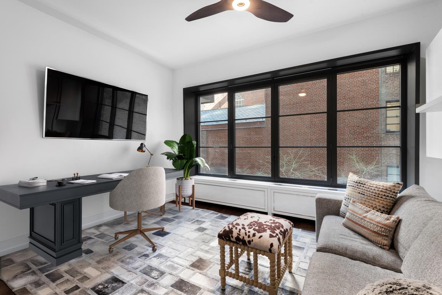 155 East 79th Street, Unit MAIS Manhattan, NY 10075 - Photo 9 of 10 a living room with furniture and a flat screen tv