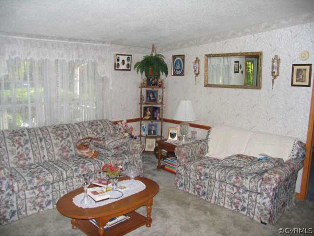 16208 Glebe Road Dewitt, VA 23840 - Photo 7 of 8 a living room with furniture and a table