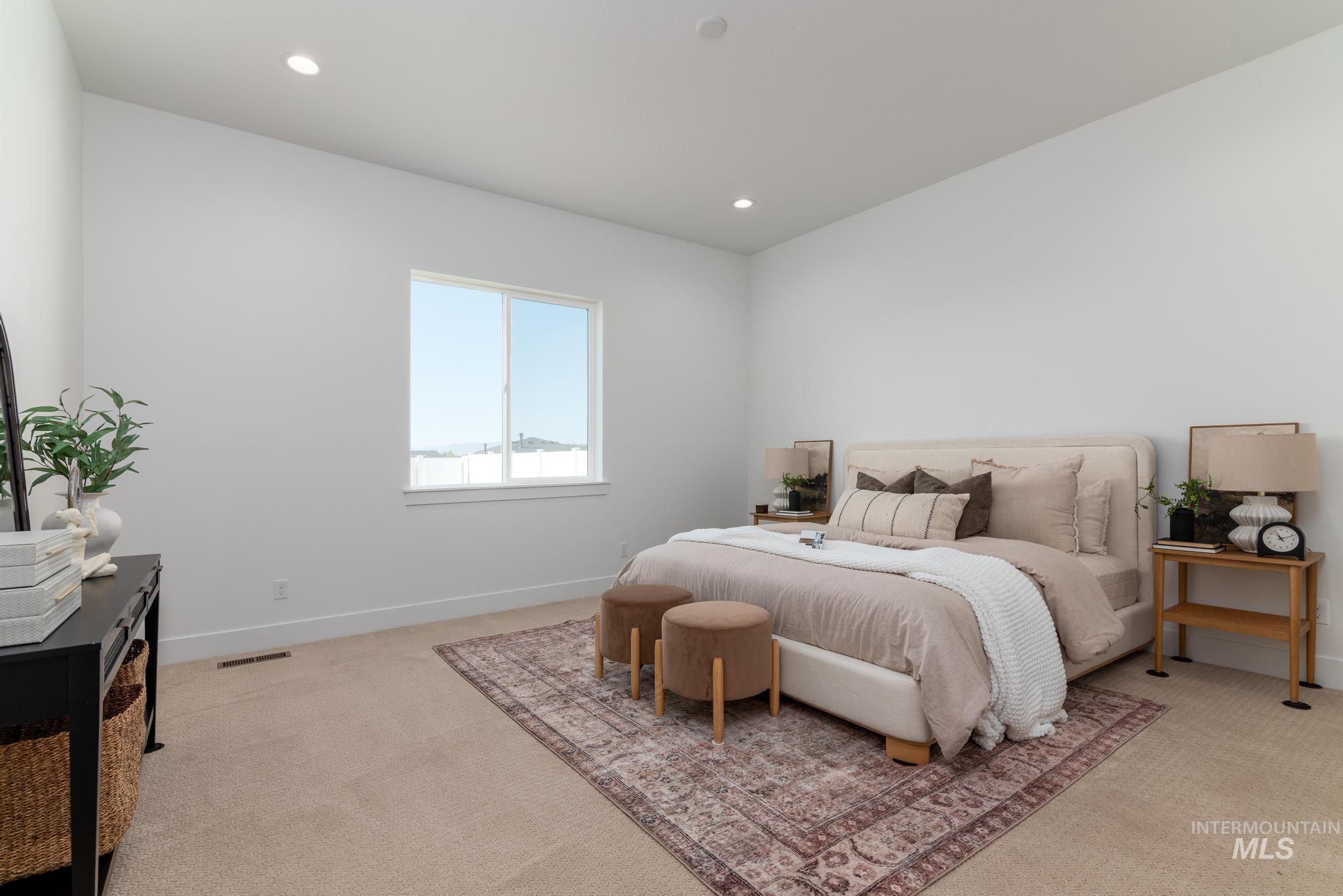 14703 Serenity Pt Street Caldwell, ID 83607 - Photo 18 of 45 Spacious bedroom featuring light-colored walls, recessed lighting, and a large window