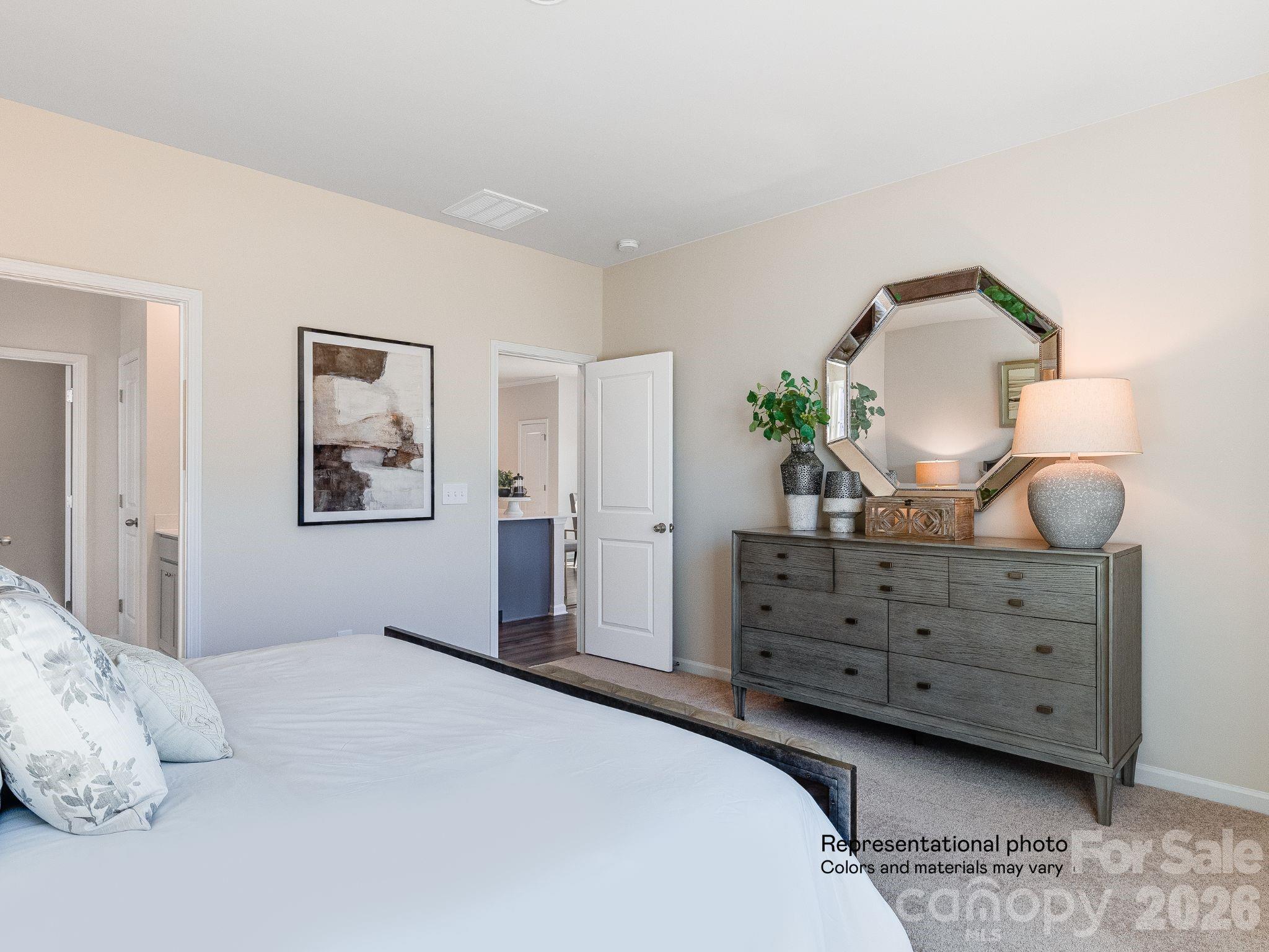 1015 Widgeon Way, Unit 203 Belmont, NC 28012 - Photo 11 of 17 a bedroom with a bed and a dresser