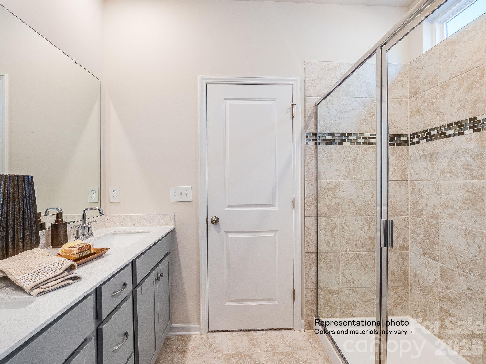 1015 Widgeon Way, Unit 203 Belmont, NC 28012 - Photo 12 of 17 a bathroom with a sink and a mirror