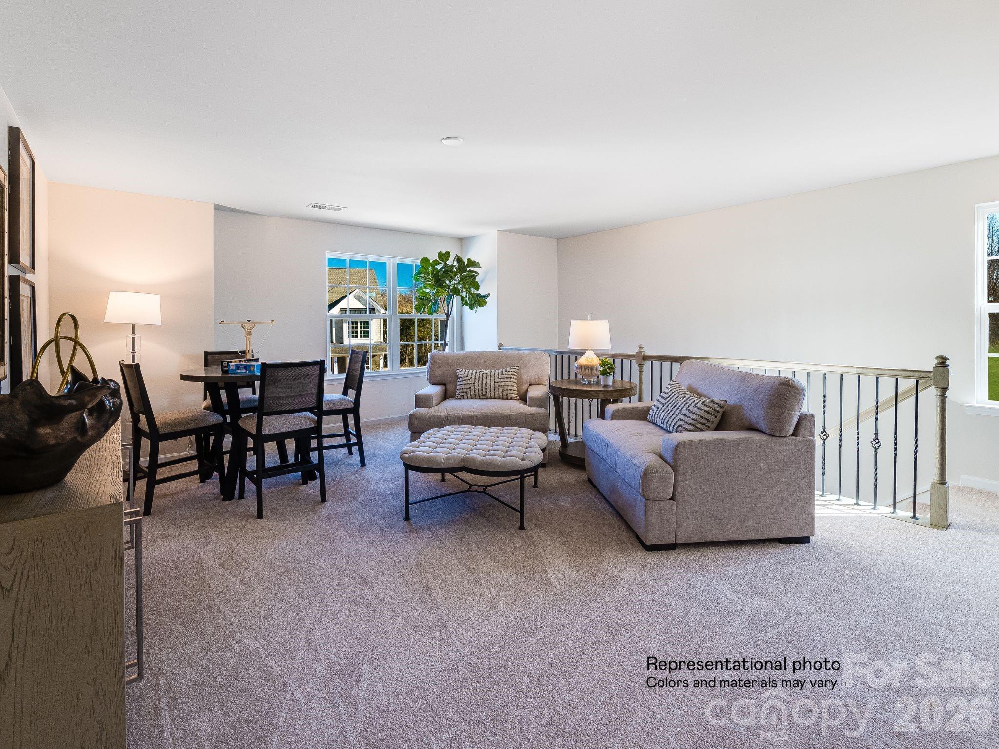 1015 Widgeon Way, Unit 203 Belmont, NC 28012 - Photo 14 of 17 a living room with furniture and a floor to ceiling window