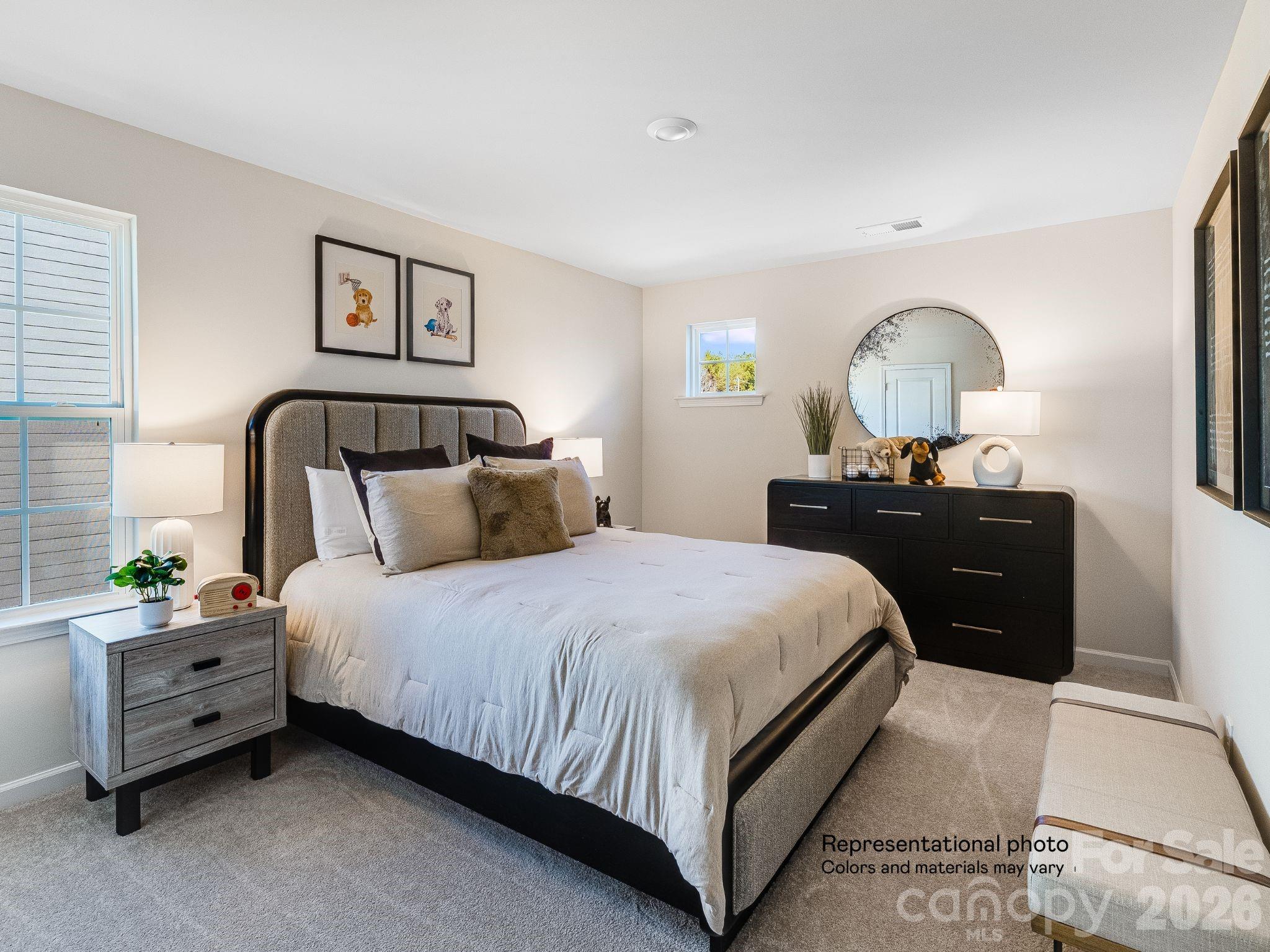 1015 Widgeon Way, Unit 203 Belmont, NC 28012 - Photo 16 of 17 a bedroom with a bed and a dresser