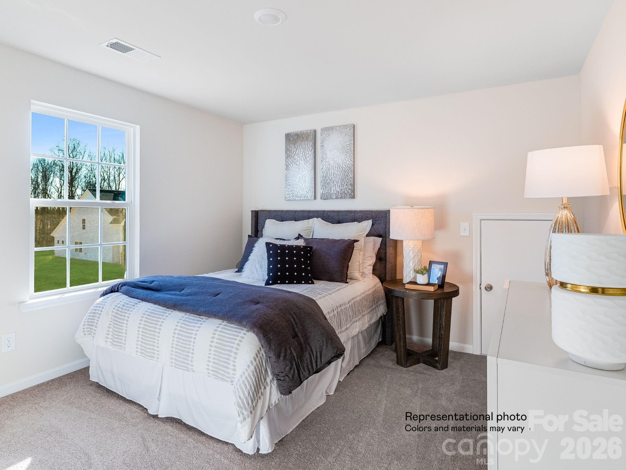 1015 Widgeon Way, Unit 203 Belmont, NC 28012 - Photo 17 of 17 a bedroom with a bed and a window