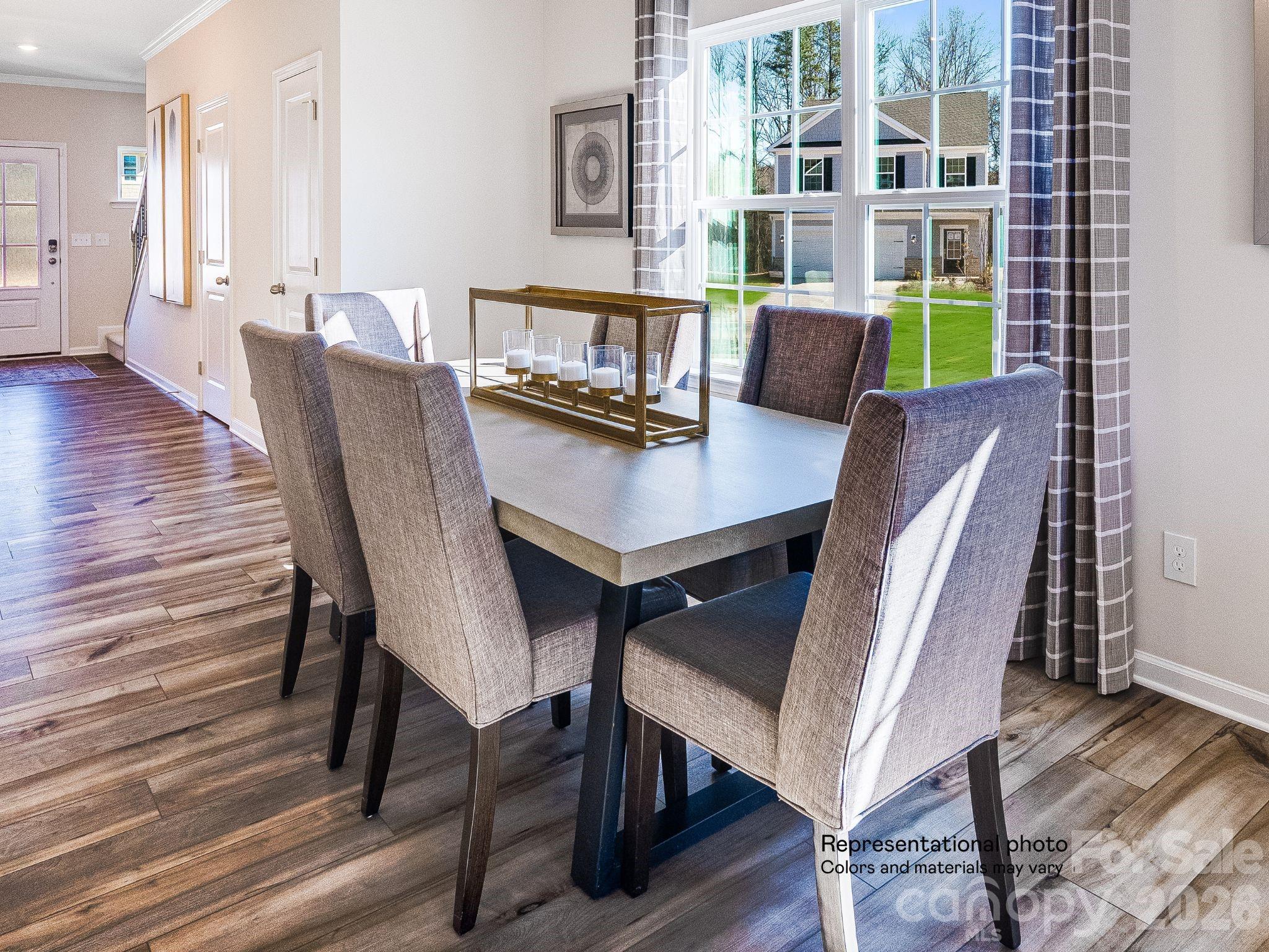 1015 Widgeon Way, Unit 203 Belmont, NC 28012 - Photo 9 of 17 a view of a dining room with furniture and wooden floor