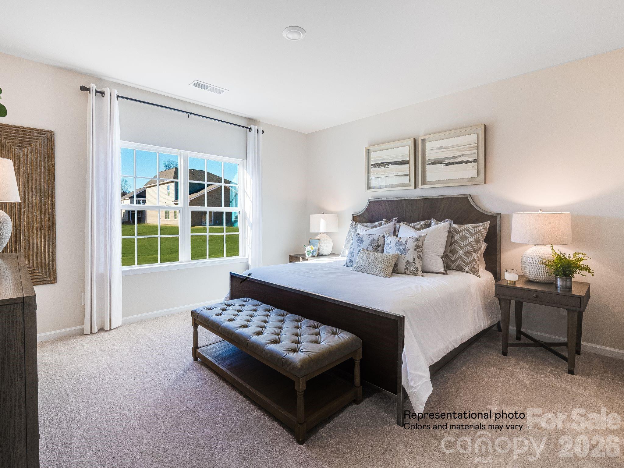 1015 Widgeon Way, Unit 203 Belmont, NC 28012 - Photo 10 of 17 a bedroom with a bed chairs and a window