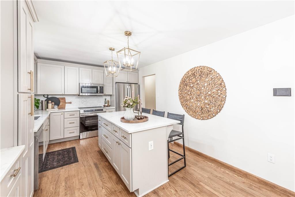 15 Watson Street Sewickley, PA 15143 - Photo 11 of 43 a kitchen with a sink stainless steel appliances a counter space and cabinets