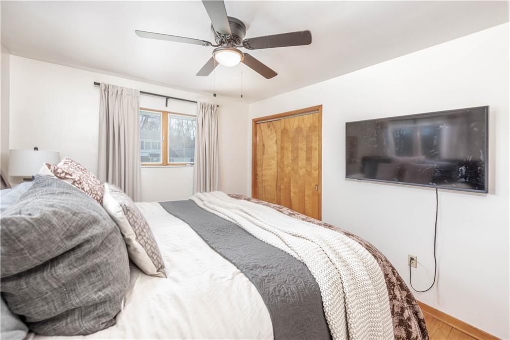 15 Watson Street Sewickley, PA 15143 - Photo 17 of 43 a bedroom with a large bed a flat tv screen and fan