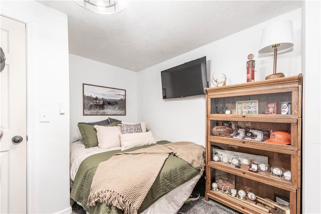 15 Watson Street Sewickley, PA 15143 - Photo 30 of 43 a bedroom with a bed and a flat screen tv