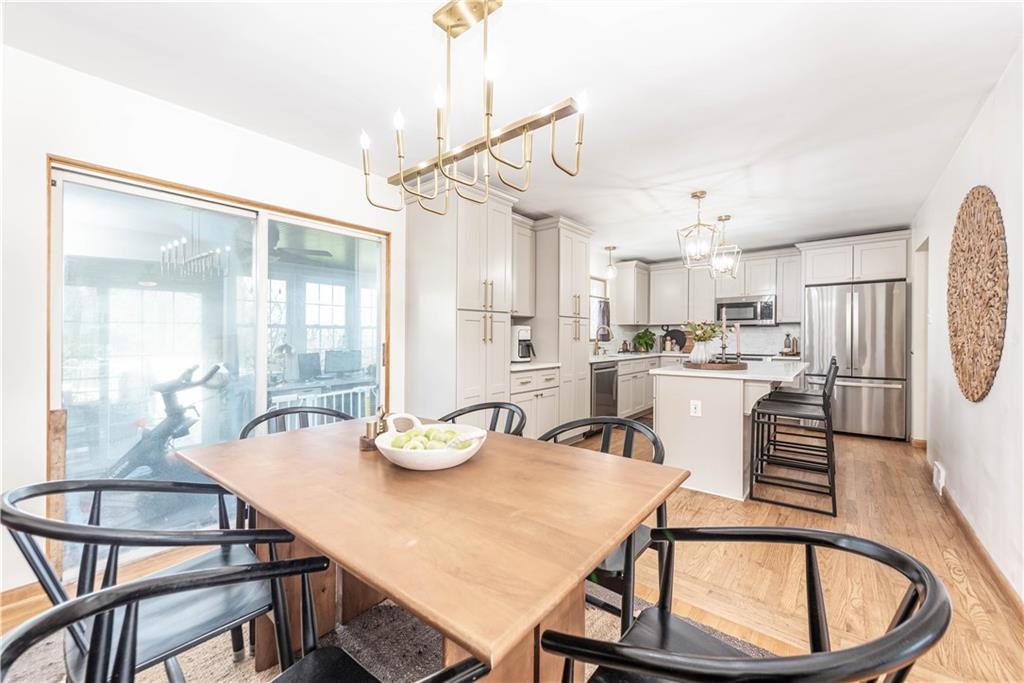 15 Watson Street Sewickley, PA 15143 - Photo 6 of 43 a kitchen with stainless steel appliances kitchen island granite countertop a dining table chairs and a refrigerator