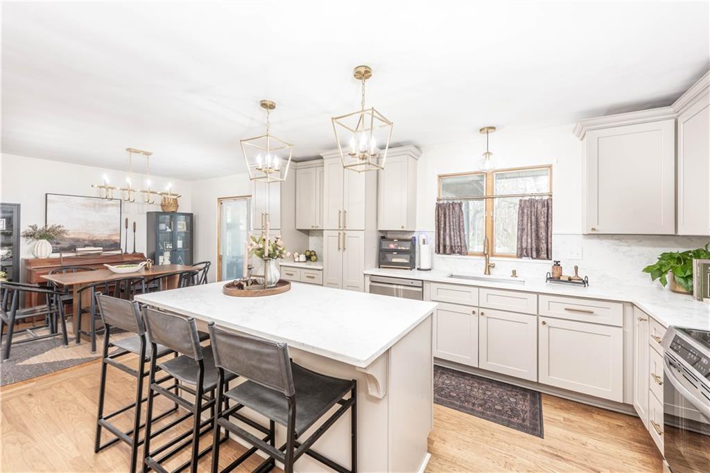 15 Watson Street Sewickley, PA 15143 - Photo 10 of 43 a kitchen with a dining table chairs sink and cabinets