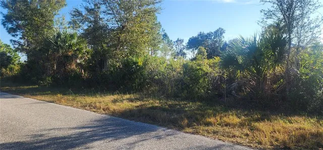 a sign board with a play ground in the back