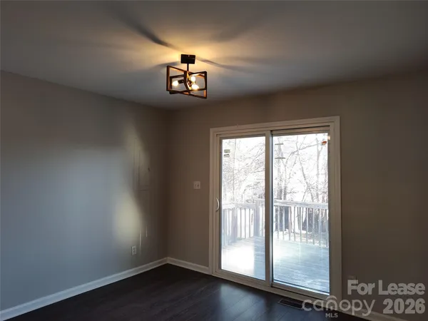 an empty room with a wooden floor and a window