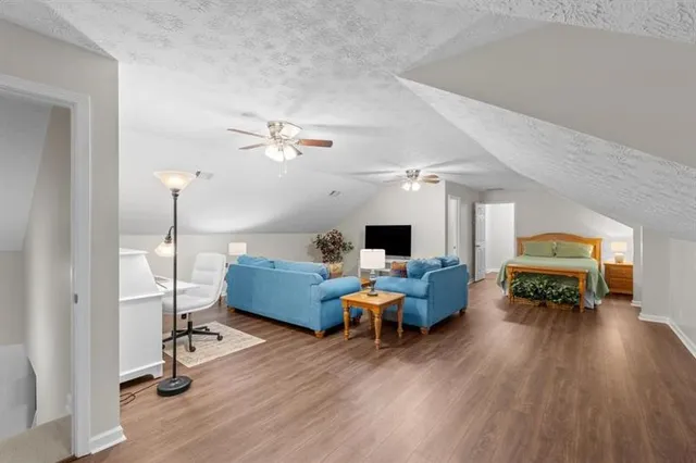 a living room with furniture and a wooden floor