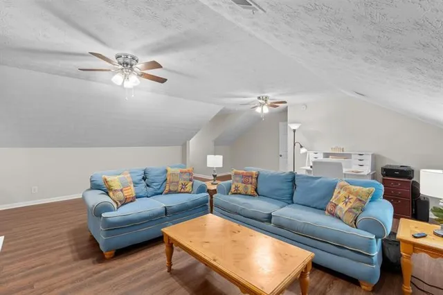 a living room with furniture and a ceiling fan