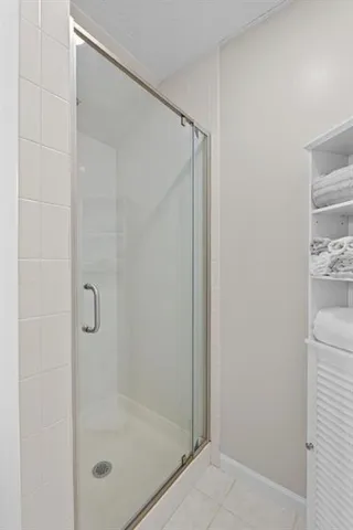 a bathroom with a glass shower door