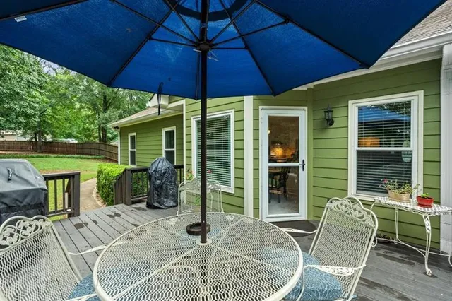 a patio with a table and chairs under an umbrella