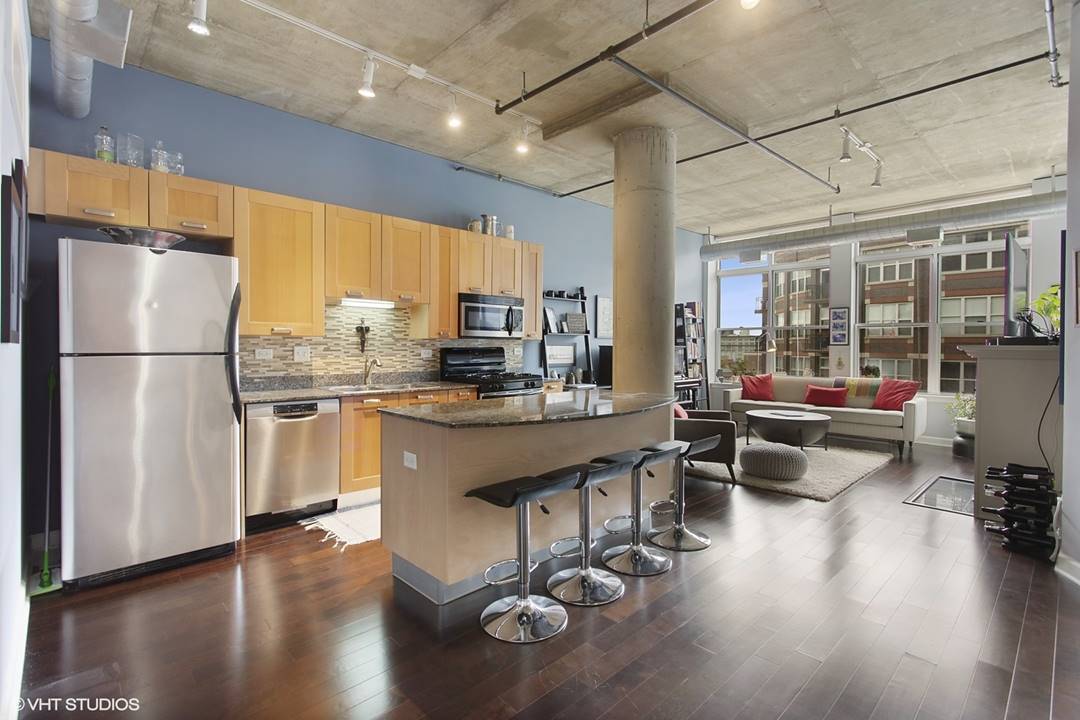 111 South Morgan Street, Unit 711 Chicago, IL 60607 - Photo 5 of 11 a kitchen with stainless steel appliances granite countertop a refrigerator a stove and a wooden floors