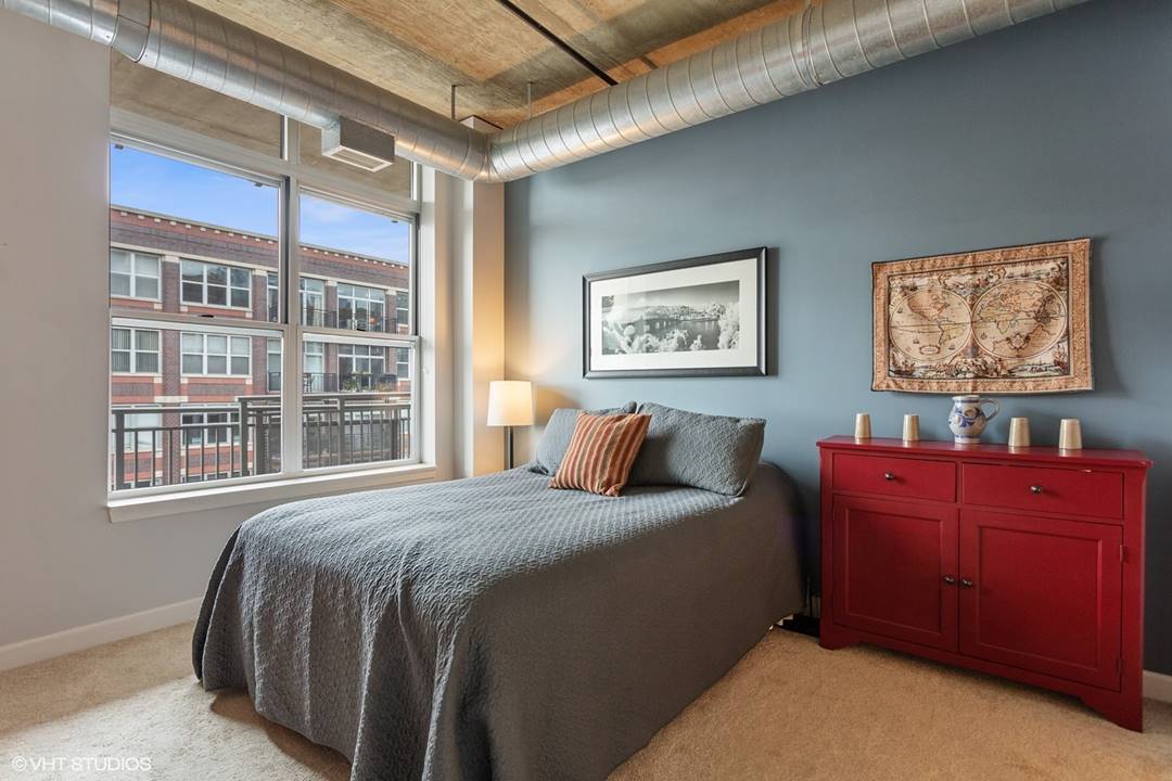 111 South Morgan Street, Unit 711 Chicago, IL 60607 - Photo 6 of 11 a bedroom with a bed and a window
