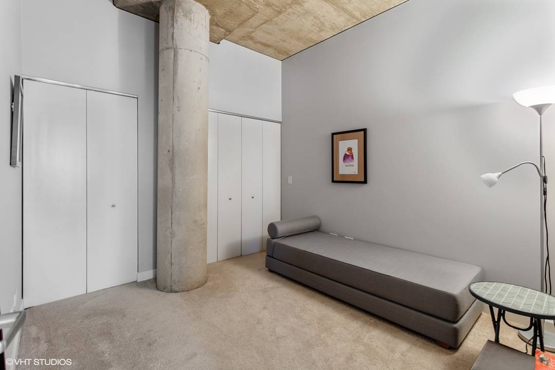 111 South Morgan Street, Unit 711 Chicago, IL 60607 - Photo 8 of 11 a spacious bedroom with a bed and a couch