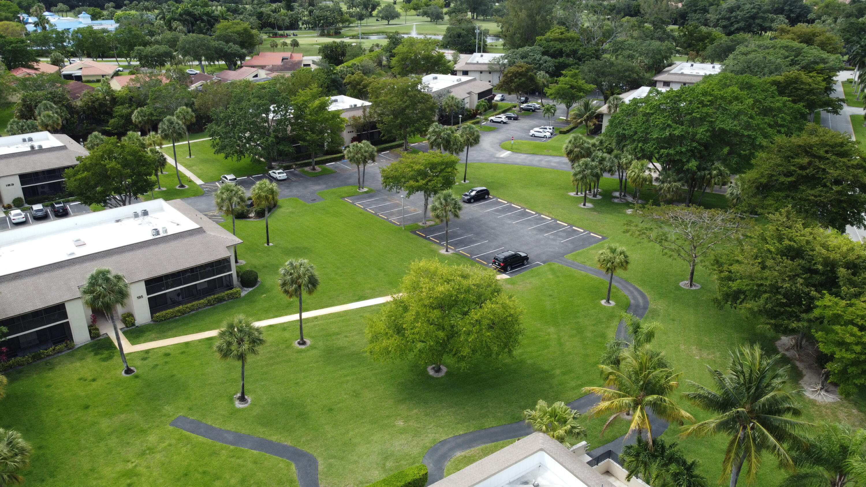297 Deer Creek Boulevard, Unit 1305 Deerfield Beach, FL 33442 - Photo 28 of 51 a view of a golf course with chairs