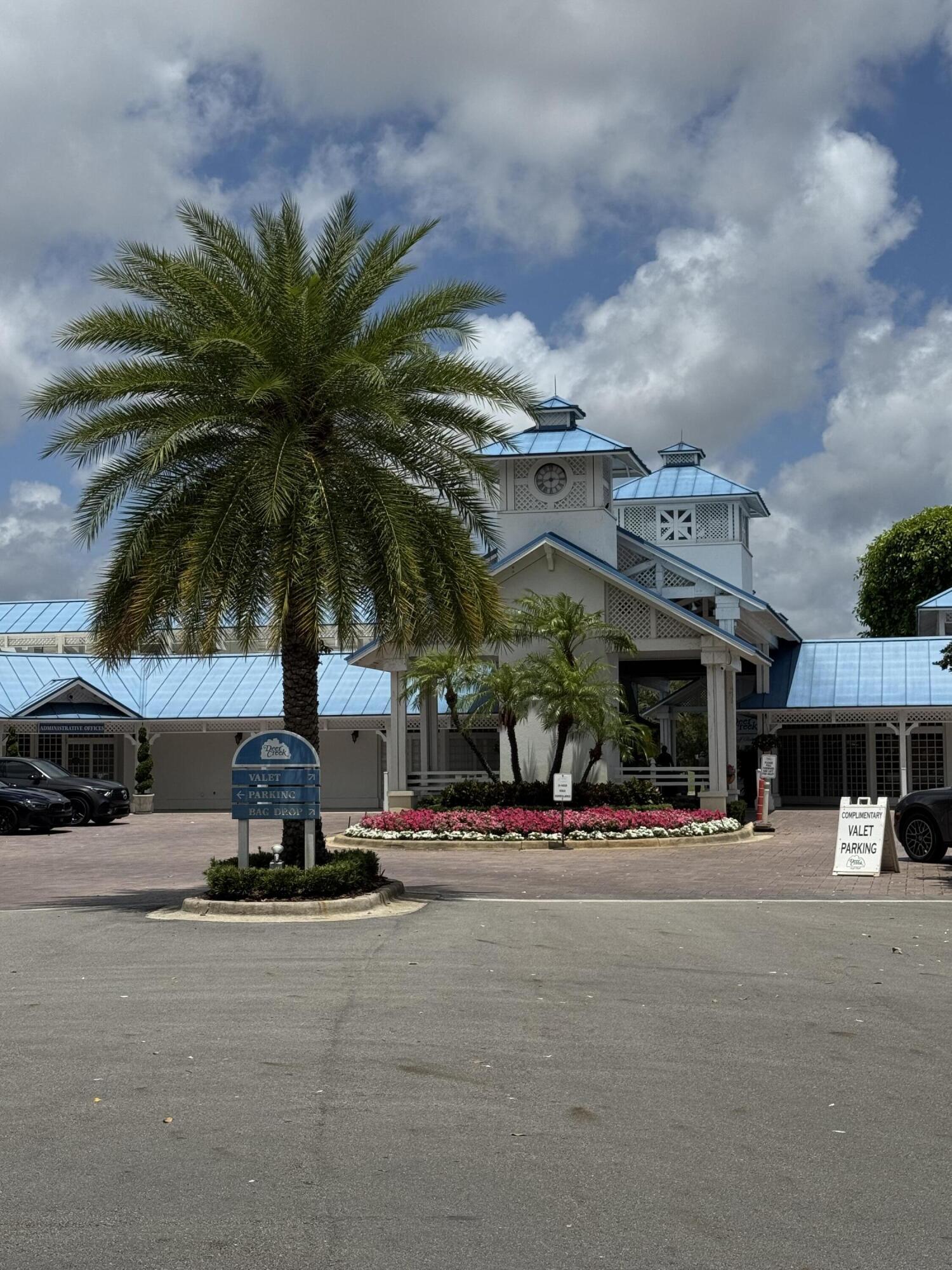 297 Deer Creek Boulevard, Unit 1305 Deerfield Beach, FL 33442 - Photo 40 of 51 a view of a building with a palm tree