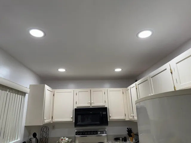 a view of kitchen with microwave and cabinets
