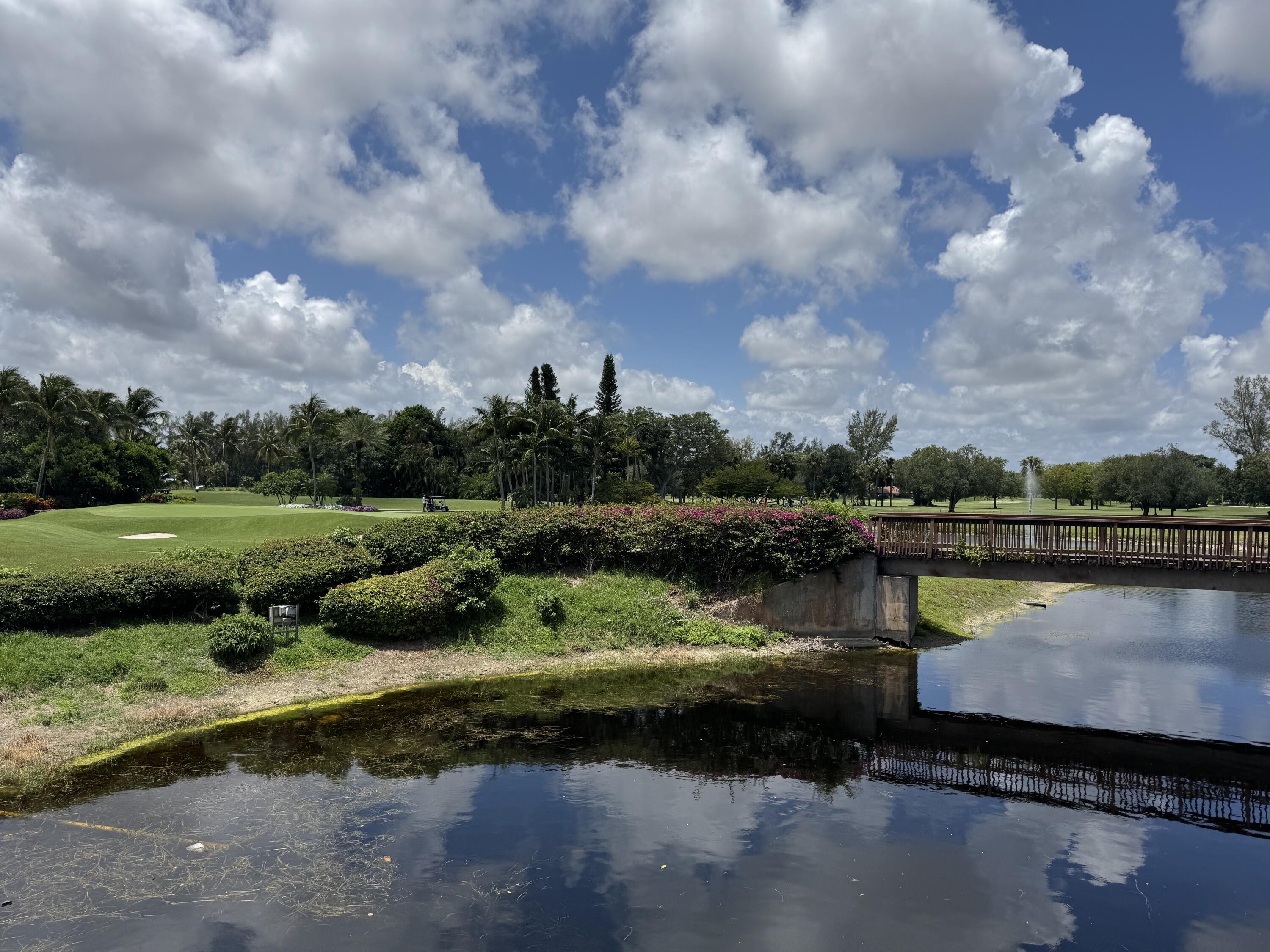297 Deer Creek Boulevard, Unit 1305 Deerfield Beach, FL 33442 - Photo 51 of 51 a view of a lake with a yard