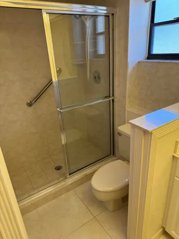 a bathroom with a toilet and shower
