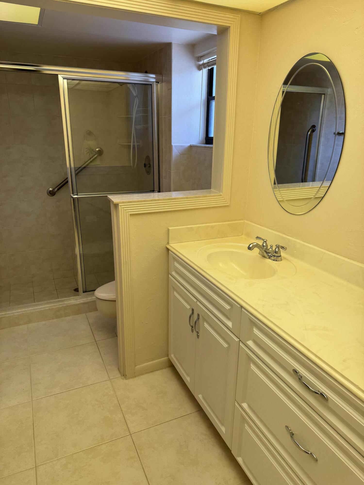 297 Deer Creek Boulevard, Unit 1305 Deerfield Beach, FL 33442 - Photo 8 of 51 a bathroom with a sink and a mirror