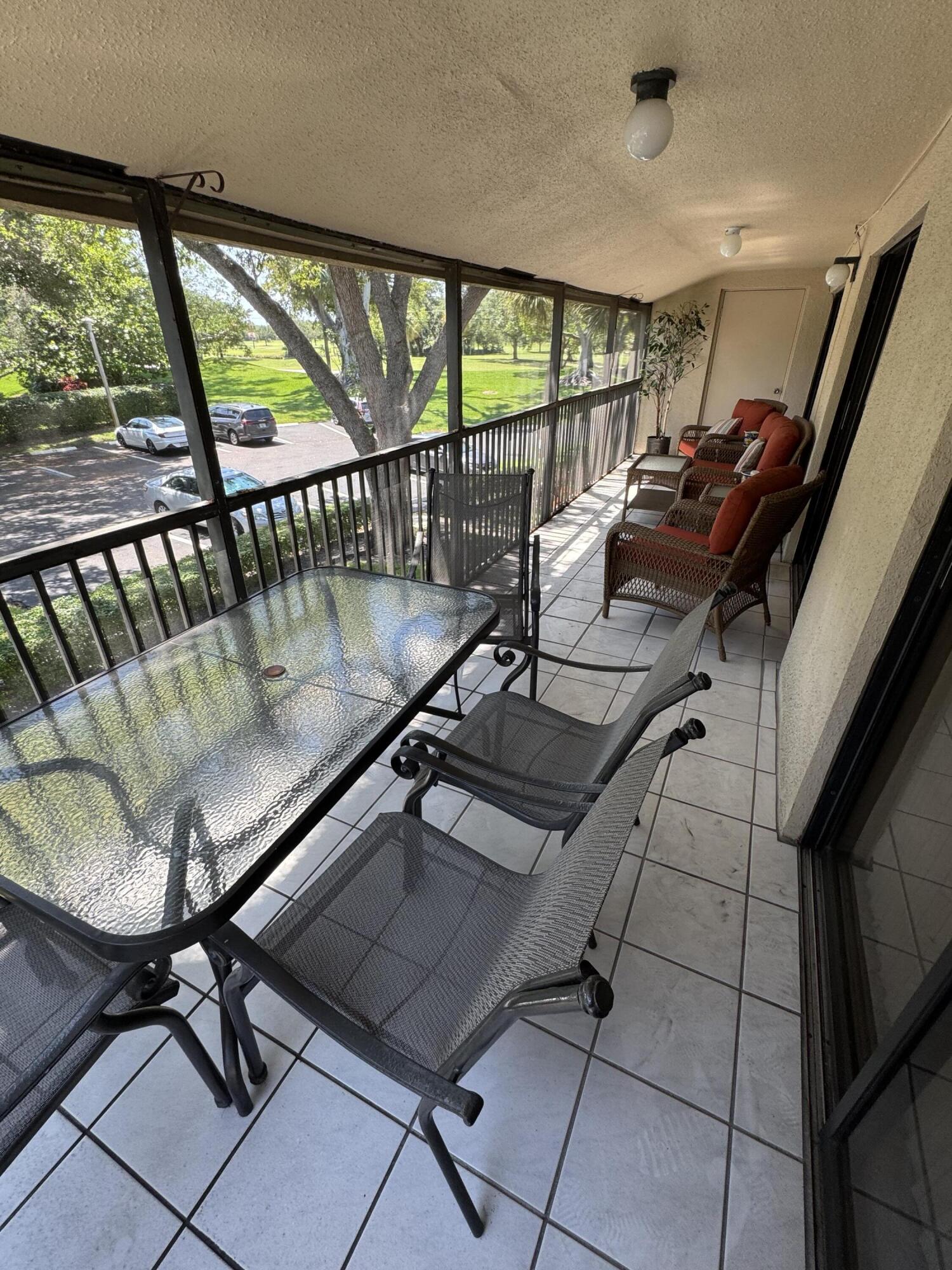 297 Deer Creek Boulevard, Unit 1305 Deerfield Beach, FL 33442 - Photo 9 of 51 a view of a chairs and table in a balcony
