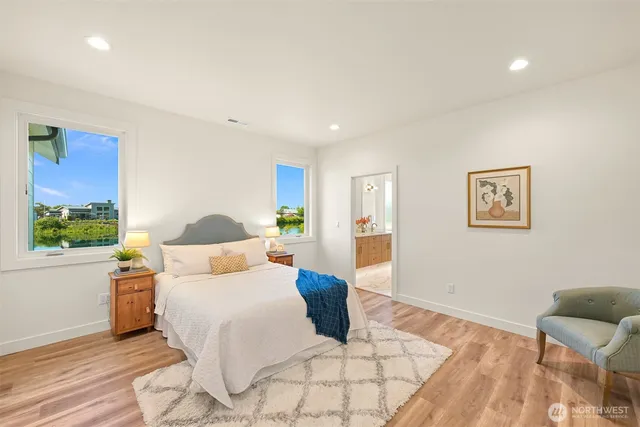 a bedroom with a bed and a large window