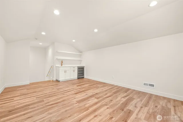 a view of an empty room with wooden floor